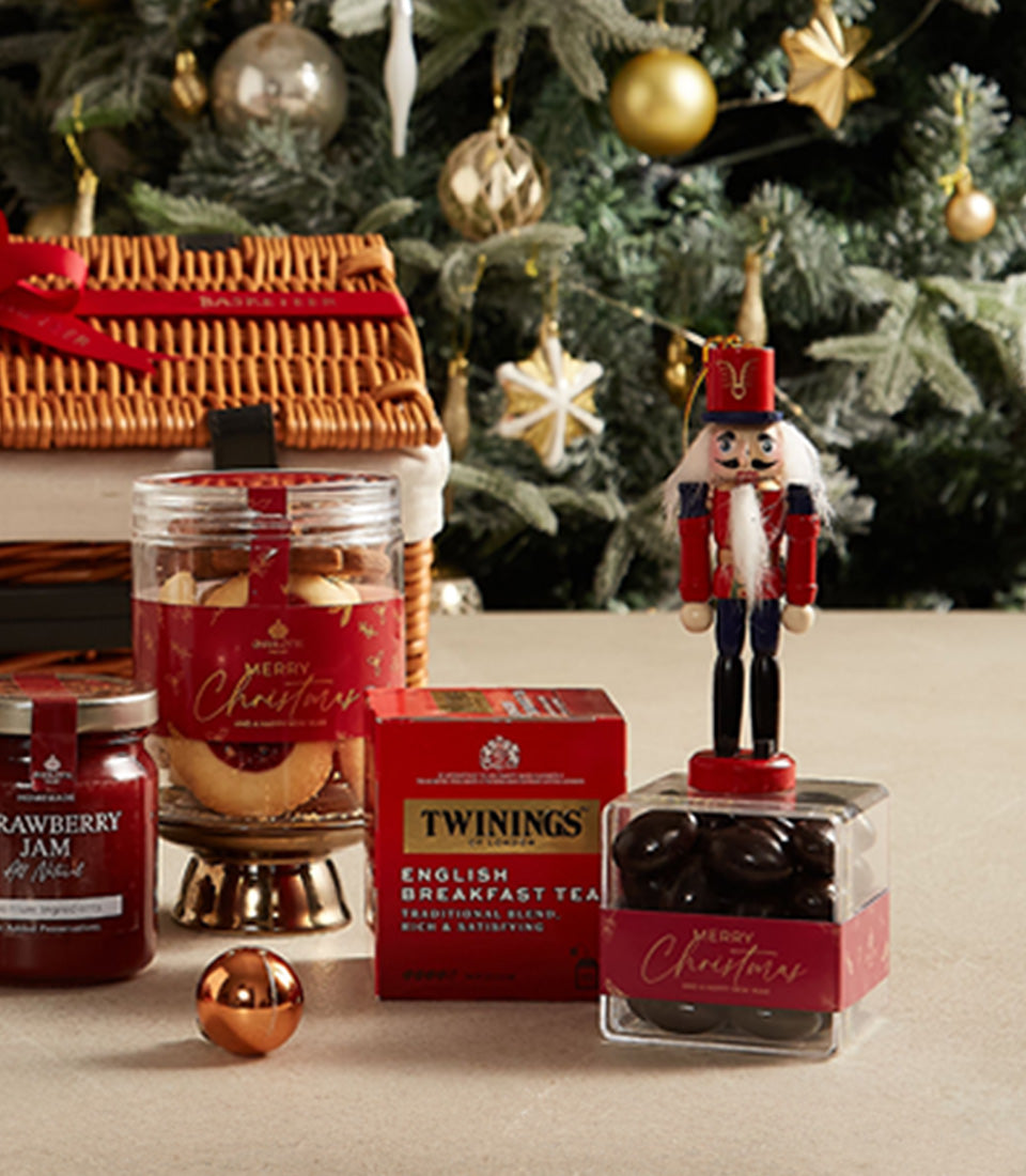 Premium Christmas hamper with strawberry jam, English breakfast tea, festive cookies, dark chocolates, and wooden nutcracker