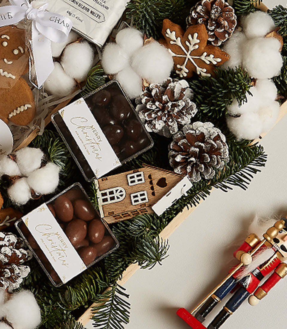 Winter Wonderland gourmet gift box with dark and milk chocolates, gingerbread cookies, and festive wooden decorations