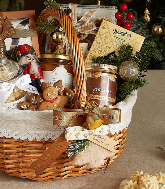 Woven wicker Christmas gift basket with gourmet marmalade, peanut butter, Whittaker's chocolates, gingerbread cookies, and