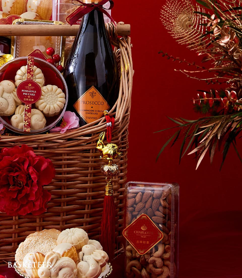 Lunar New Year gourmet basket with Prosecco, pineapple cakes, and roasted nuts in woven wicker