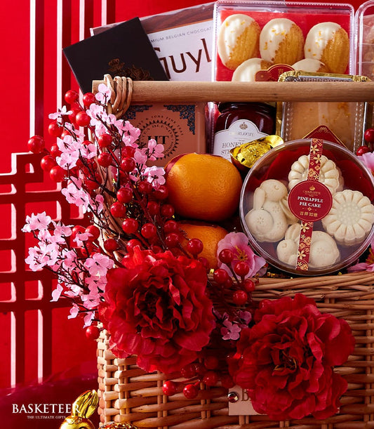 Lunar New Year wine and gourmet hamper with Belgian chocolate, honey sticks, and Charlotte pastries on red festive background