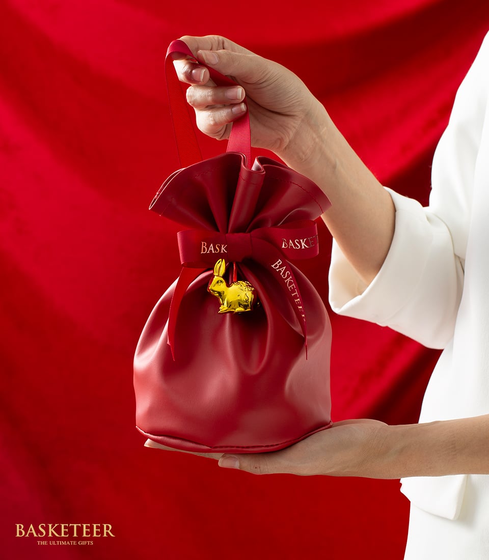 Lunar New Year red drawstring gift pouch with golden rabbit charm and Basketeer ribbon bow