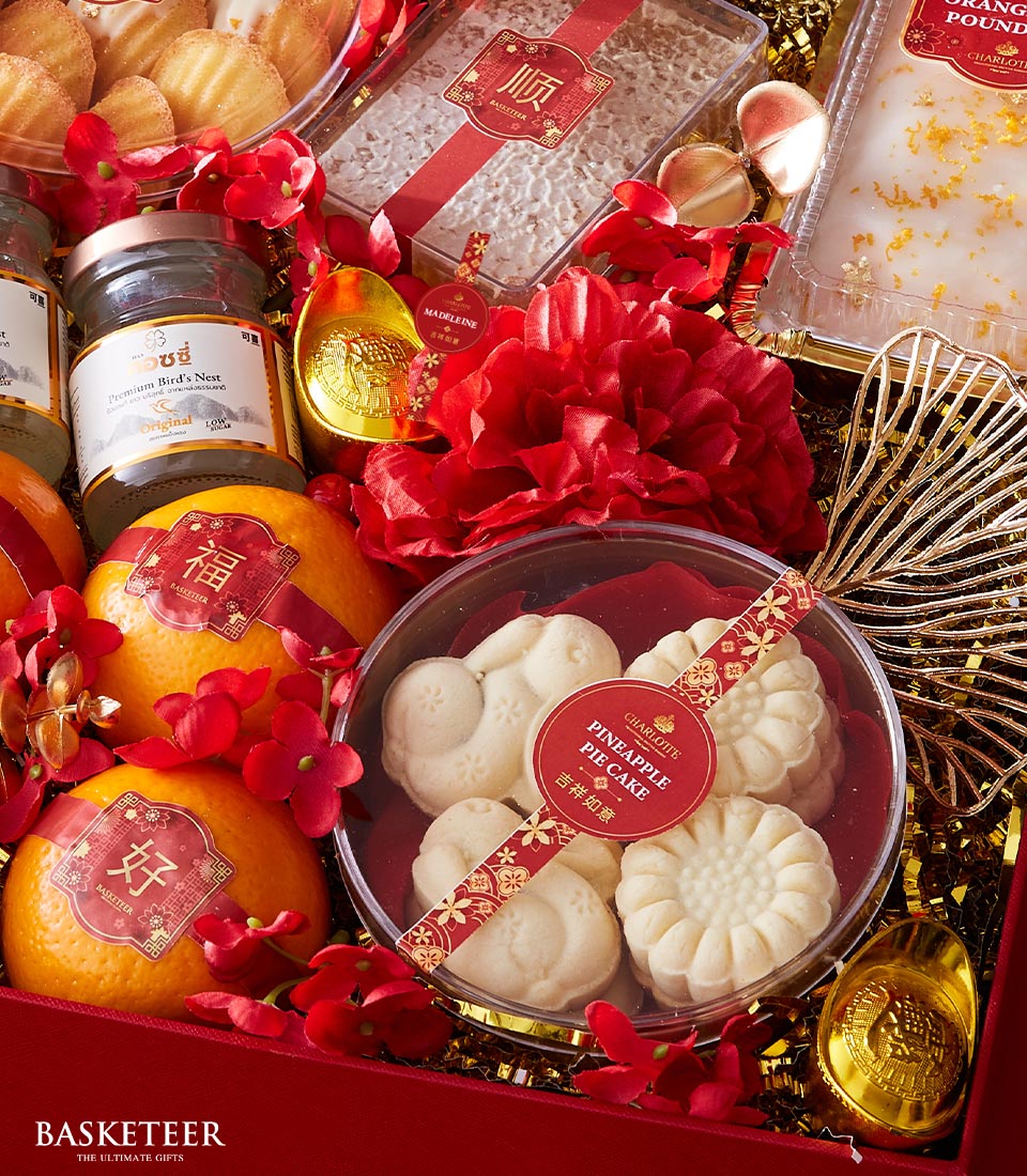 Vibrant red and gold luxury gift basket with mandarin oranges, premium bird's nest, pineapple pie cakes, madeleines, and
