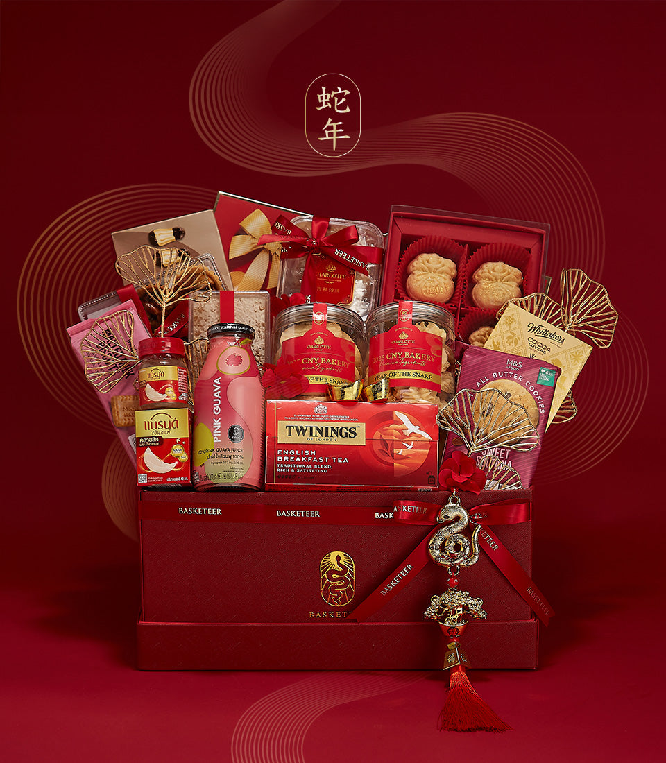 Premium red Lunar New Year gift basket with gourmet treats, artisan cookies, tea, and chocolate in gold-accented packaging