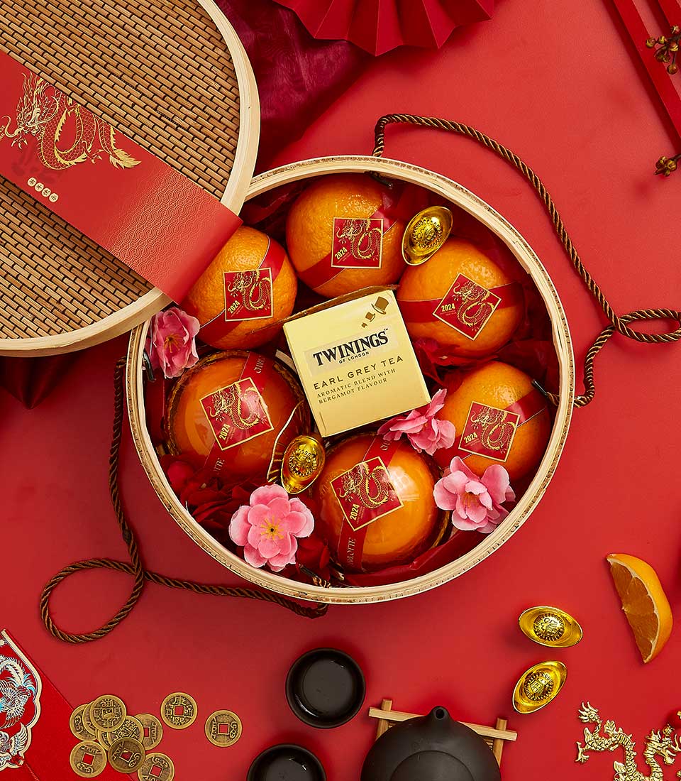 Basketeer premium Lunar New Year gift basket: oranges with red ribbon, Twinings tea, & gold accents. Perfect for same-day gift delivery in Bangkok, Thailand.