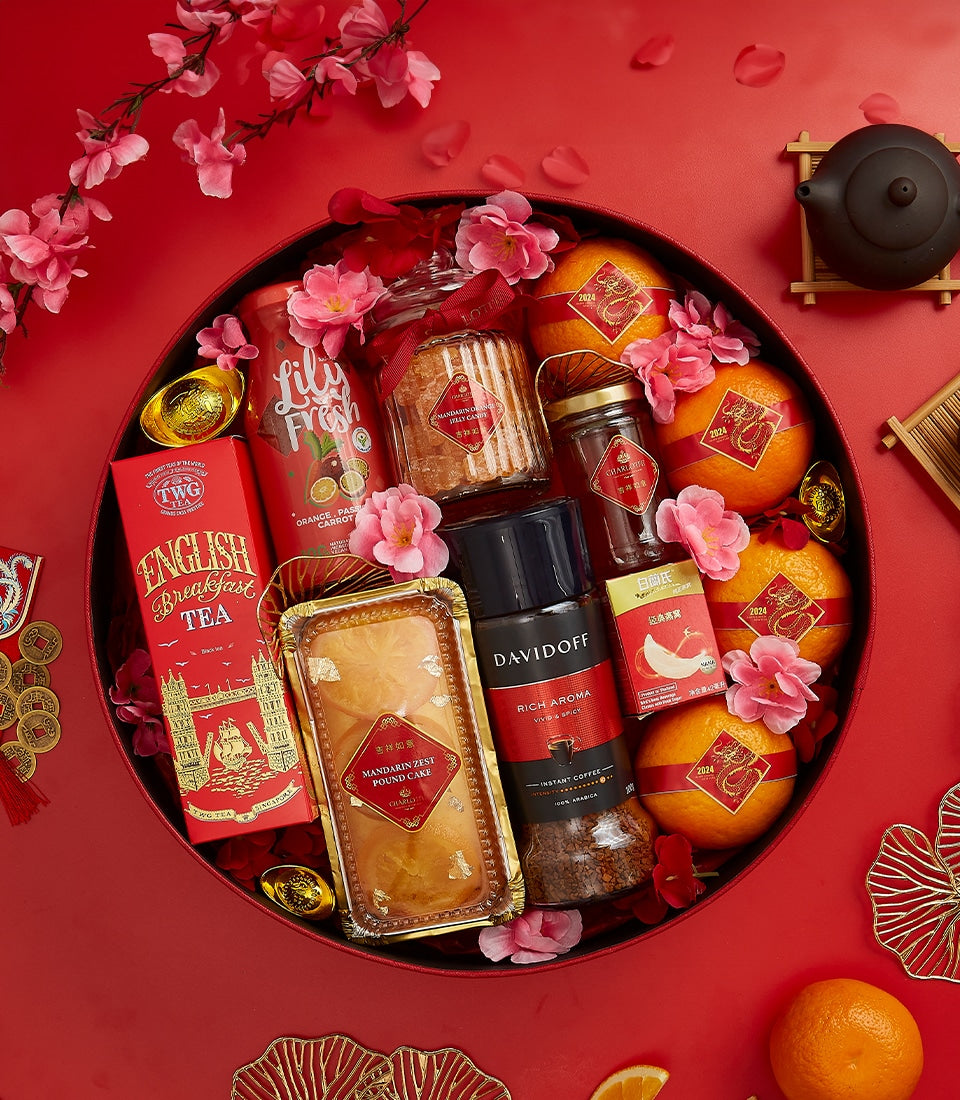 Lunar New Year red gift hamper with tea, coffee, cake, mandarins, and gold accents