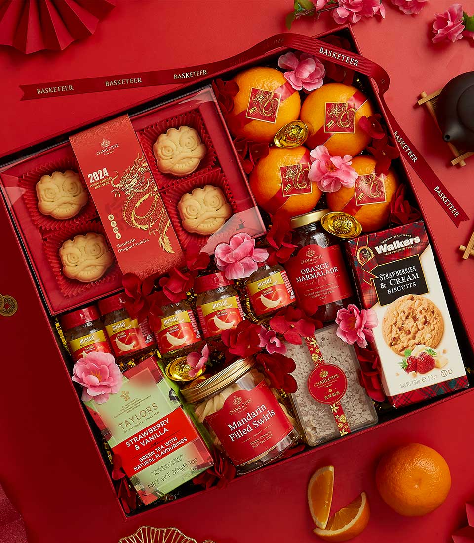 Luxury red CNY gift box with mandarin oranges, artisan cookies, marmalade, and premium baked goods for Chinese New Year