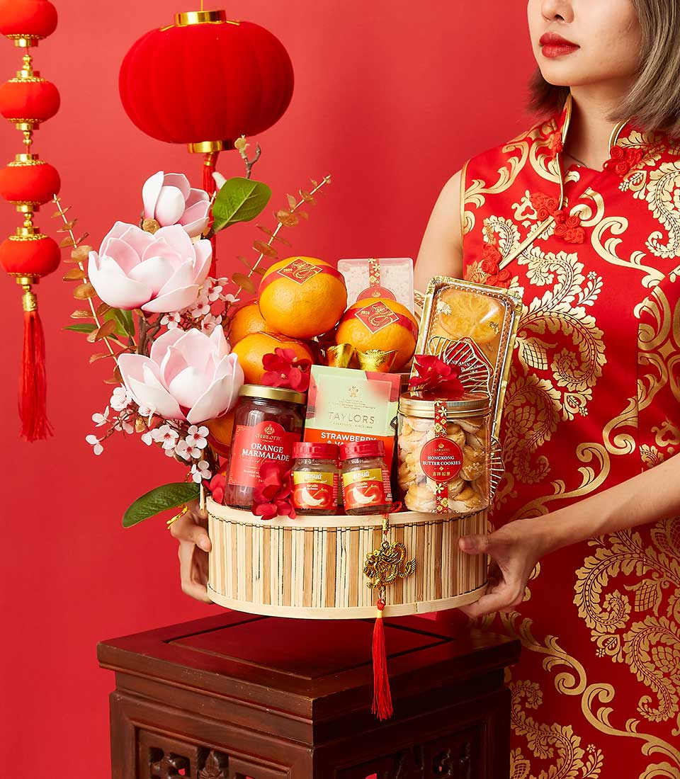 Lucky red hamper with marmalade, butter cookies, and fresh fruit for Chinese New Year celebration