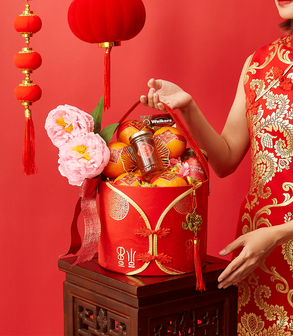 Red cylindrical CNY gift basket with mandarin oranges, marmalade, shortbread, peonies and gold dragon charm