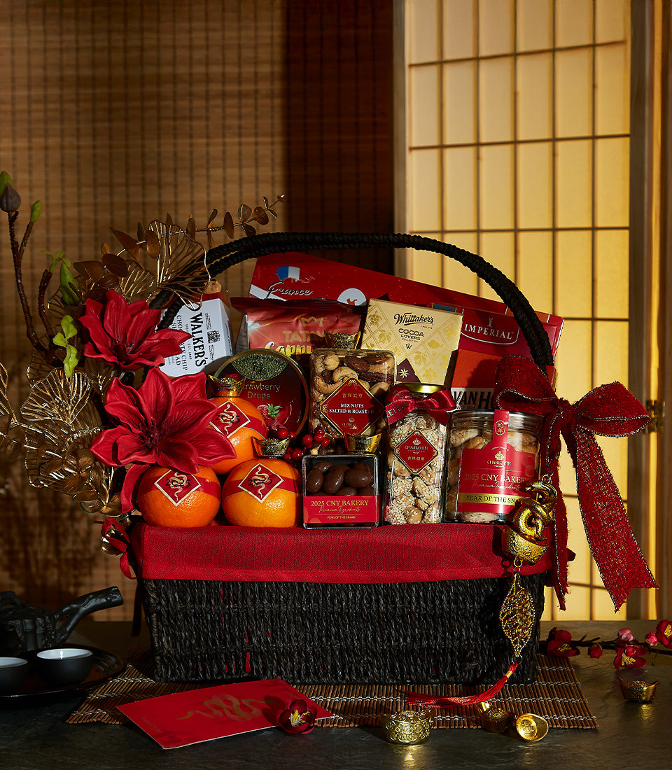 Luxe woven gift basket with gold dragon oranges, gourmet nuts, chocolates, and red festive ribbons for Chinese New Year