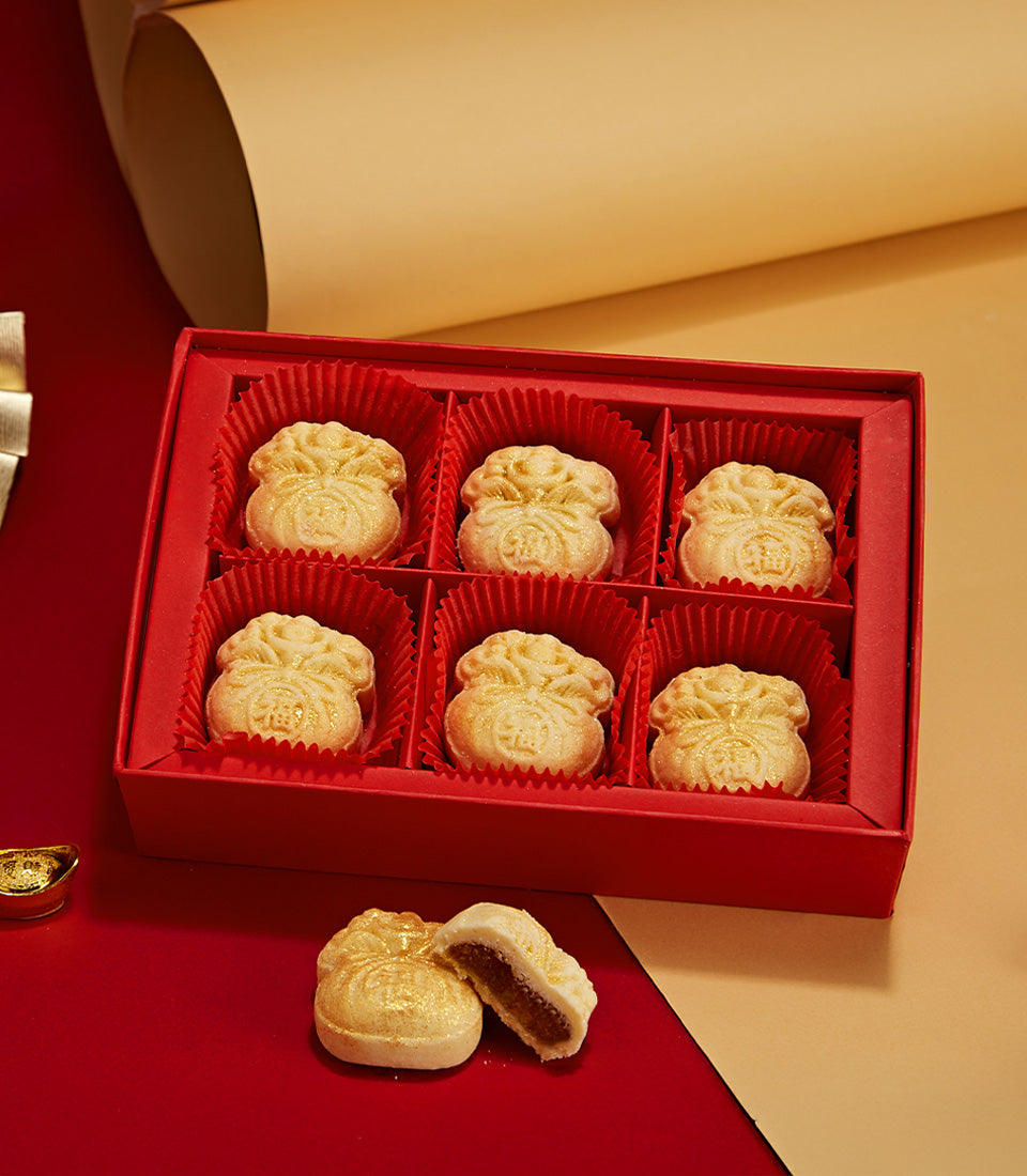 Red gift box with six golden cheese tarts shaped like money bags, embossed with Chinese character, perfect for Lunar New