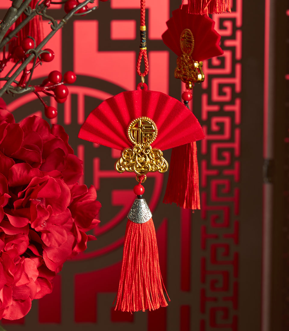 Red berry and hydrangea arrangement with gold "Fu" medallion charm for Chinese New Year gifting