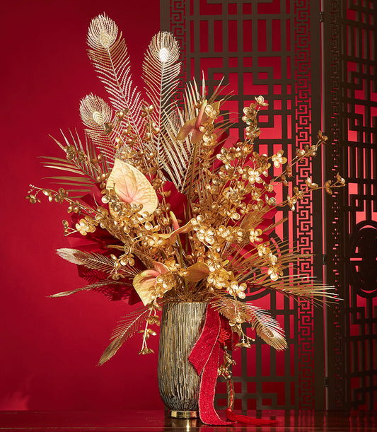 Basketeer's premium Chinese New Year gift: Gold floral arrangement with feathers, anthuriums, and red ribbon. Perfect corporate gift Bangkok.