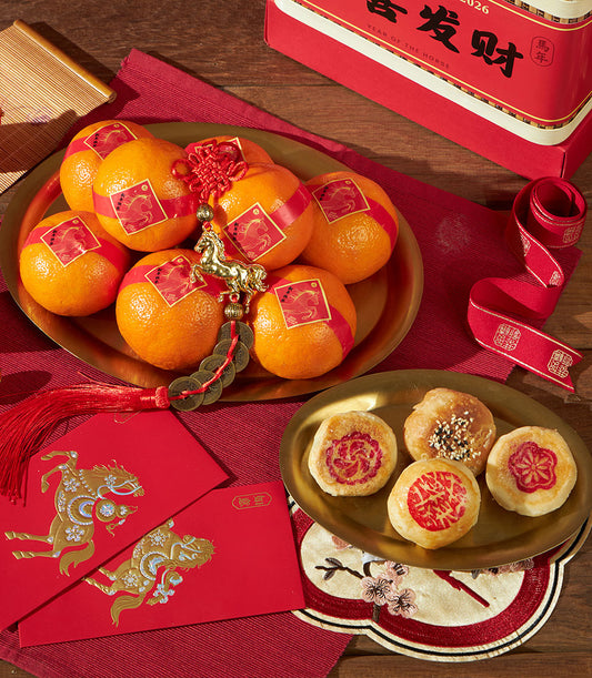 Mandarin oranges with golden horse charm and traditional pastries in red and gold Chinese New Year gift set