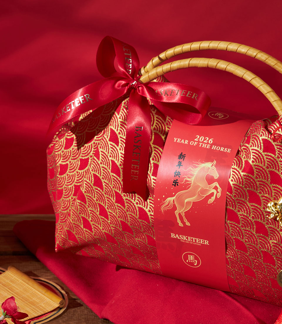 Red fabric gift bag with gold wave pattern and satin ribbon, perfect for Chinese New Year gifting