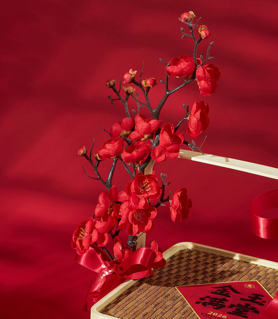 Festive red fabric flower branch with mandarin oranges gift box and lucky red envelope for Chinese New Year