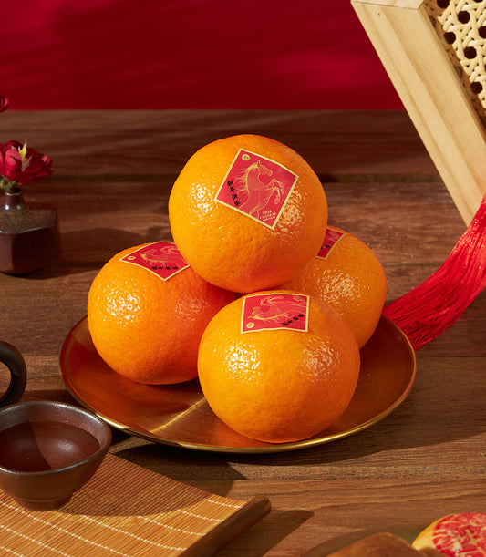 Mandarin oranges with golden horse stickers and pastries on golden plate for Chinese New Year celebration