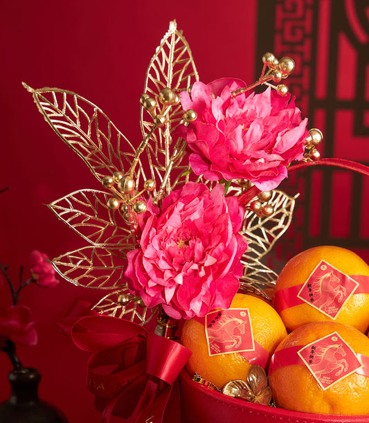 Chinese New Year mandarin orange basket with red ribbon, artificial pink peonies and gold foliage arrangement