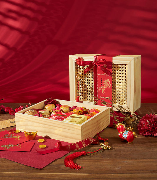 Premium Chinese New Year gift box with mandarin oranges, Twinings tea, mooncakes, and festive red and gold accents