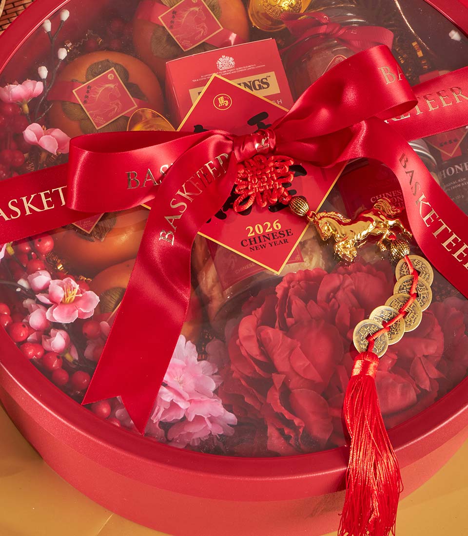 Luxury red gift basket with persimmons, premium tea, honey, and cherry blossoms for Chinese New Year 2026