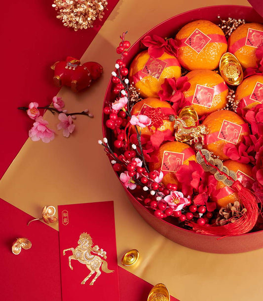 Premium red gift box with fresh mandarins, red flowers and cherry blossoms for Chinese New Year