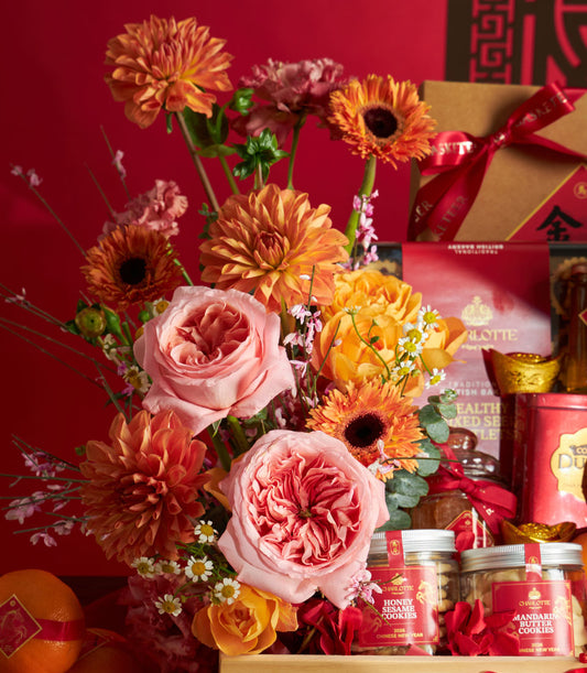 Luxury Chinese New Year gift basket with pink and coral roses, festive gourmet cookies, golden ingots, and red gift packaging