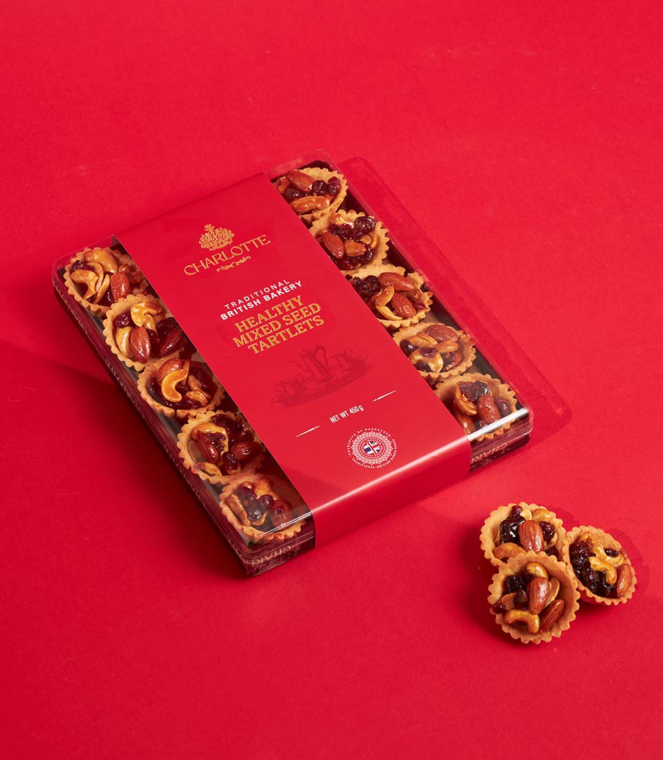 Charlotte Bakery healthy mixed seed tartlets in gold-embossed red gift box, artisan British baked treats for festive gifting