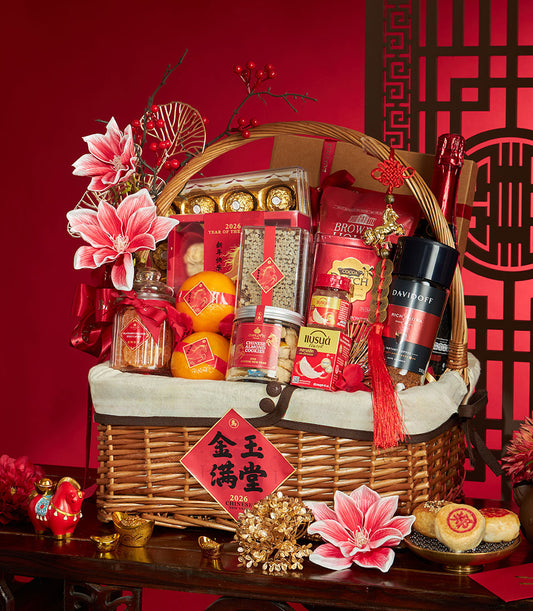 Premium Chinese New Year gift basket with golden chocolates, almond cookies, oranges, and festive red accents