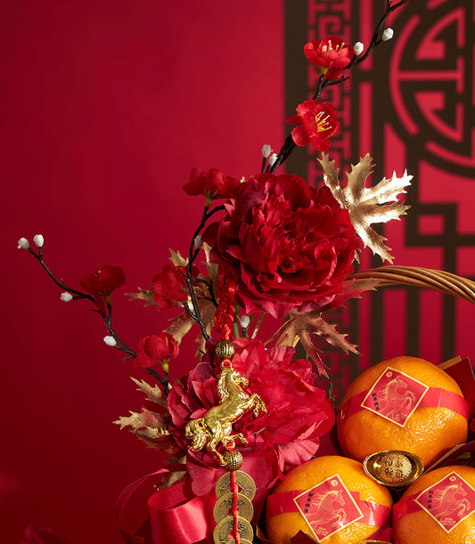 Luxury mandarin orange gift basket with red ribbon, golden horse charm, and festive peonies for Chinese New Year 2026