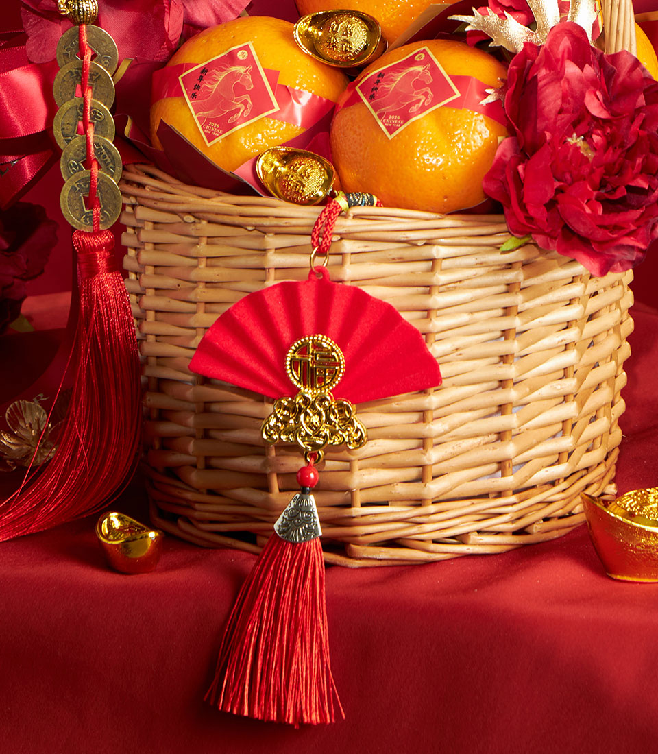 Luxury mandarin orange gift basket with red silk ribbons, golden coin charm, and Fu character fan for Chinese New Year