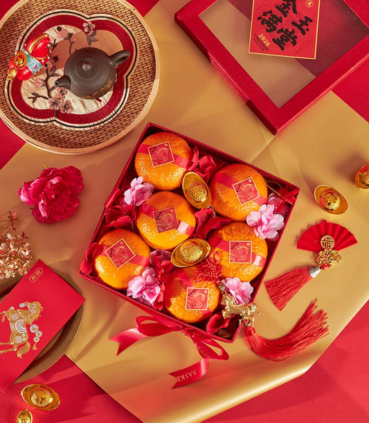 Prosperity Mandarin Orange Gift Box with gold horse charms, red envelopes, and festive Chinese New Year ornaments