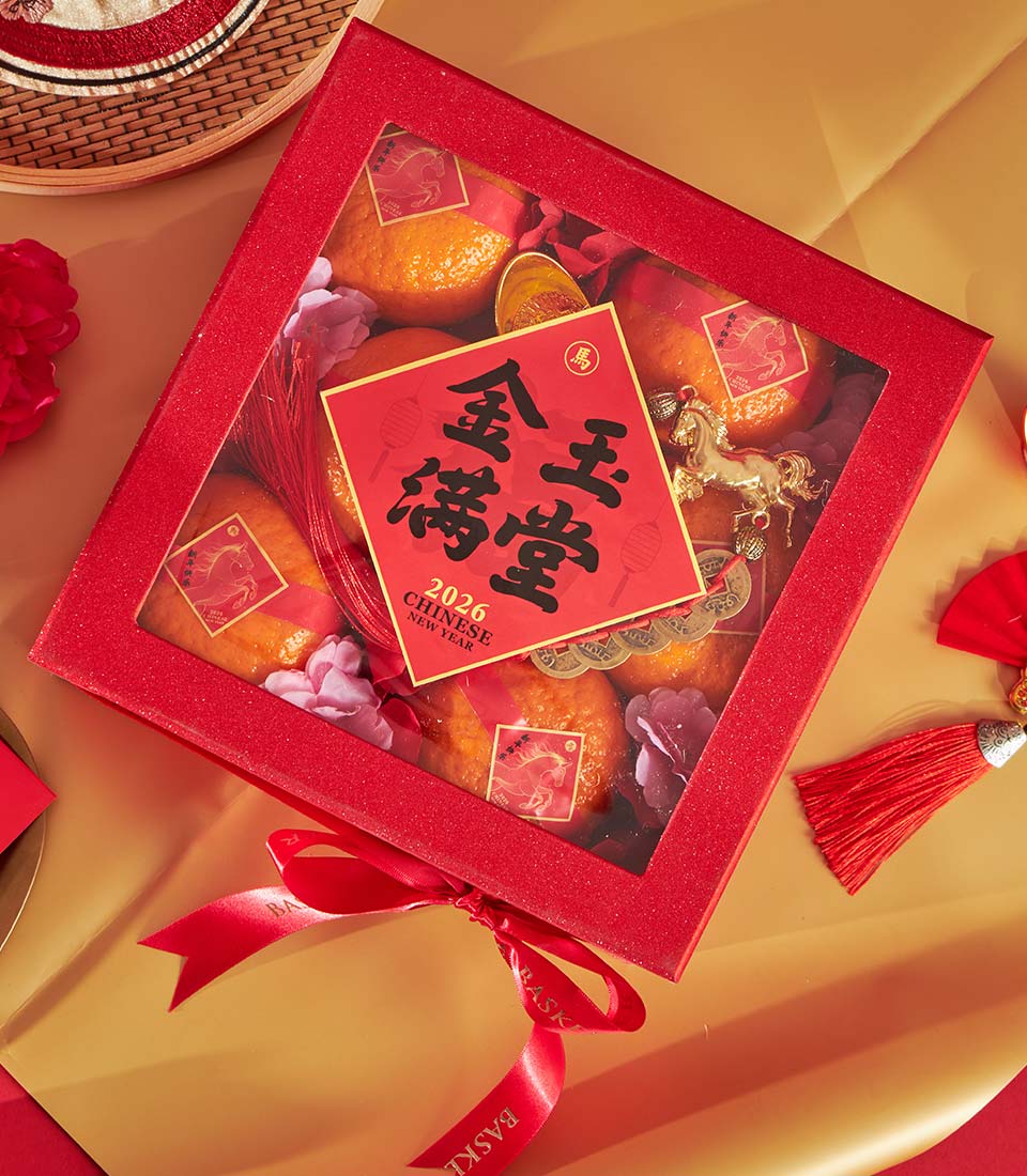 Red glittery gift box with mandarin oranges, golden horse figurine, and Chinese New Year 2026 celebration details
