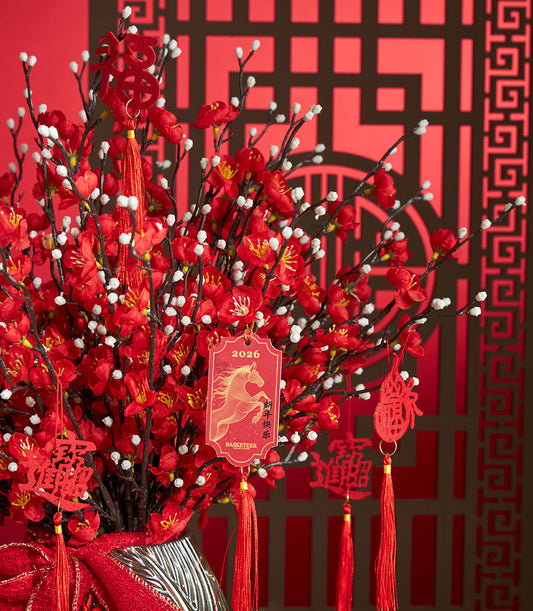 Basketeer Chinese New Year gift: Red cherry blossom branches and festive tassels artfully arranged in a decorative vase with rich red ribbon. A premium hamper delivery for Bangkok.