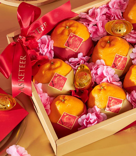 Golden Dekopon oranges with prosperity gold ingots and pink florals in luxury gift box