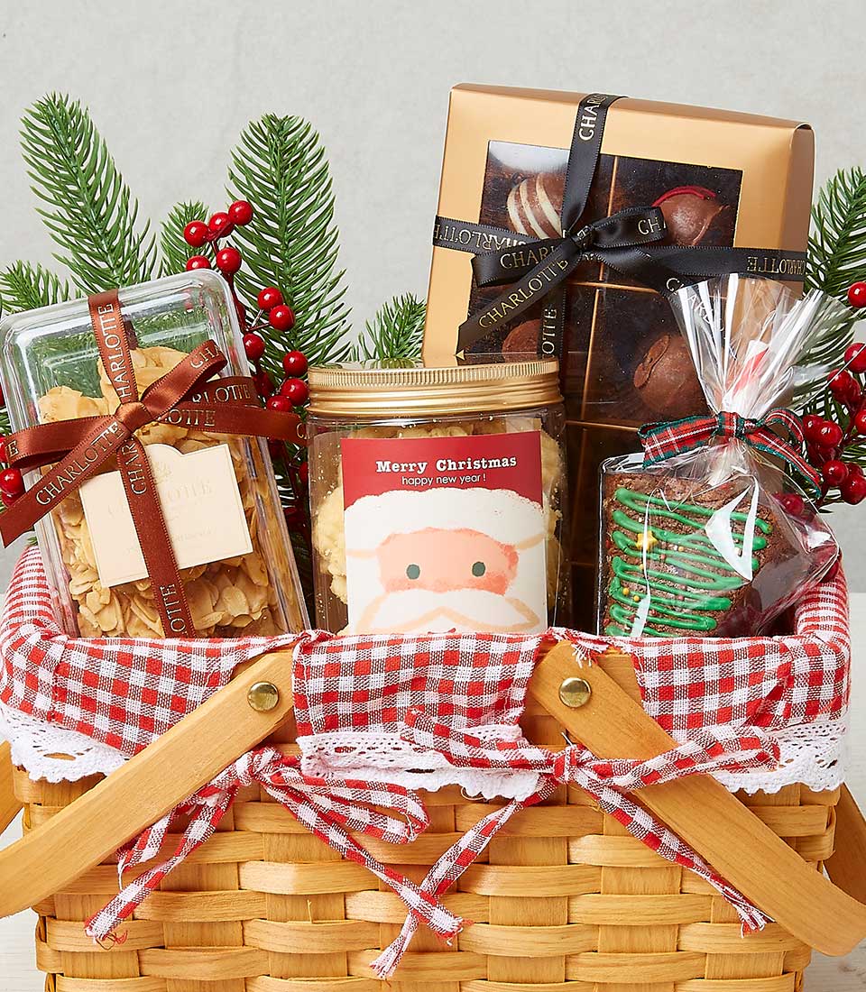 Festive Christmas gourmet hamper with almond florentines, shortbread, chocolates, and tree-shaped brownie in woven basket