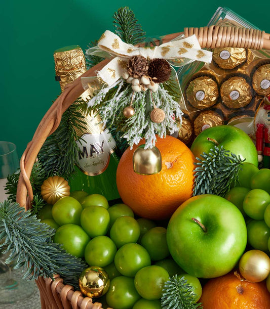 Premium Christmas fruit basket with green apples, plums, oranges, Ferrero Rocher chocolates and festive gold accents