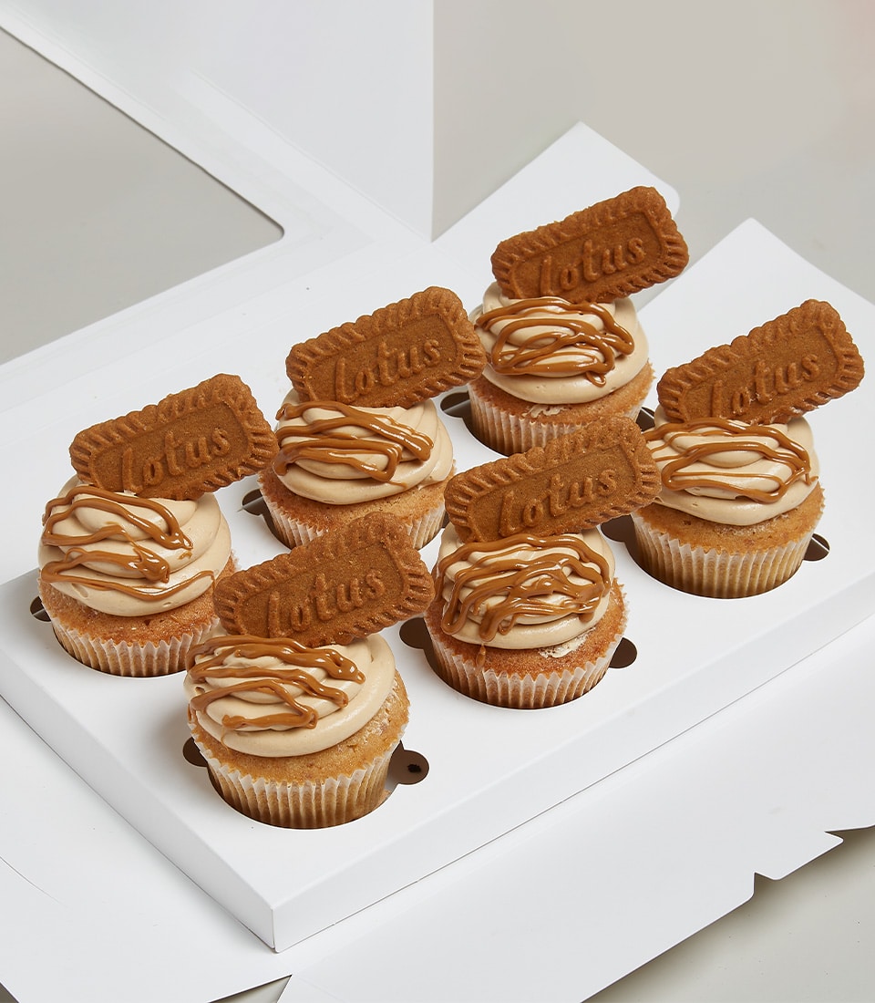 Eight Lotus Biscoff cupcakes with caramel frosting and cookie toppers in white gift box