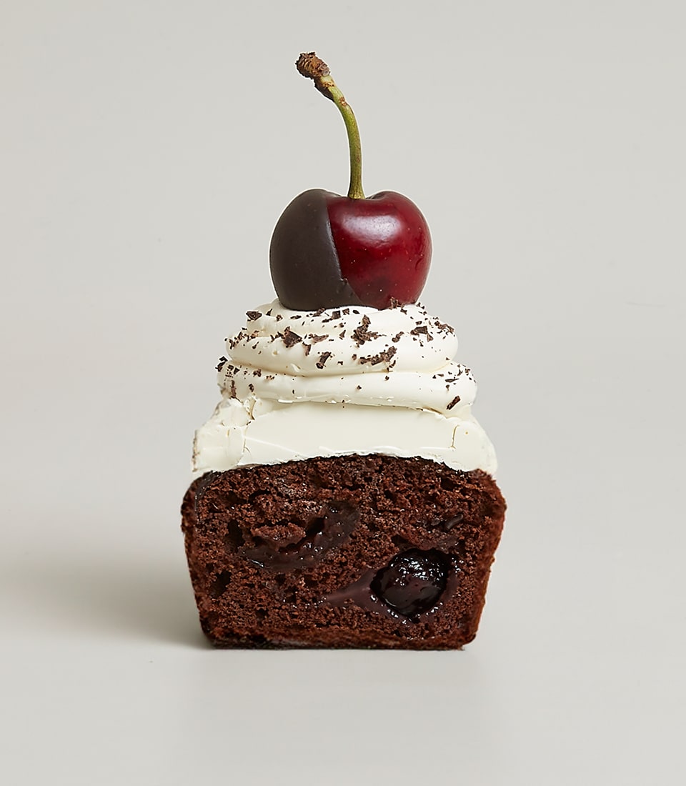 Dark cherry chocolate cupcake with whipped cream and chocolate shavings, artisan bakery gift