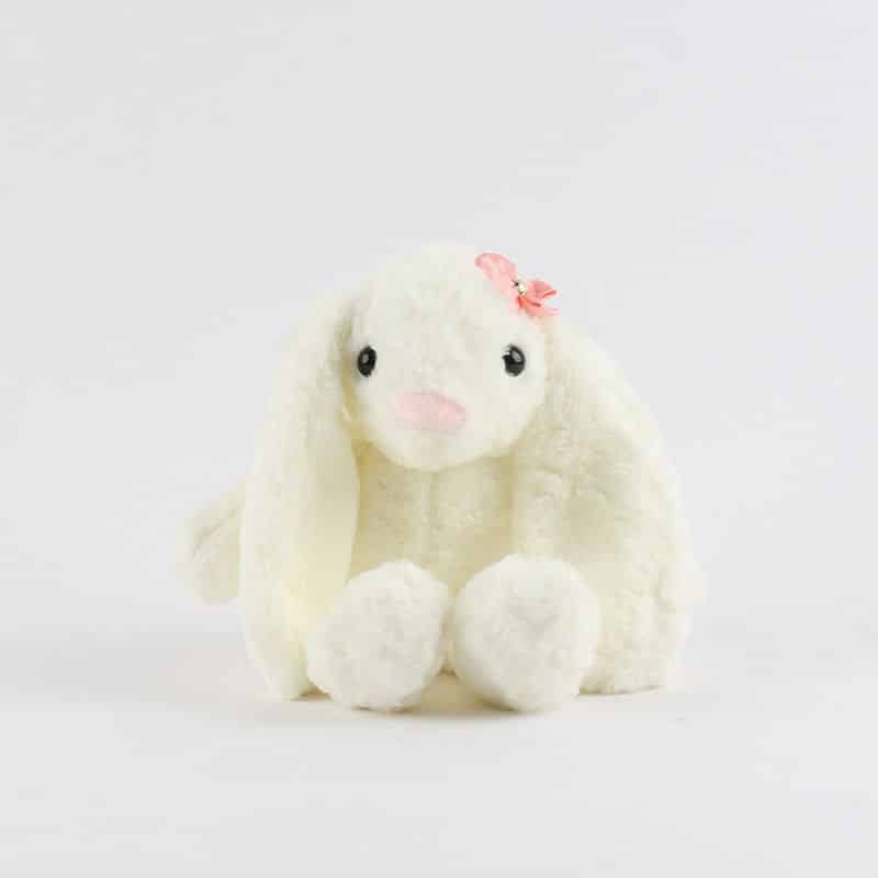 Cream plush bunny with floppy ears and pink flower detail, soft gift toy