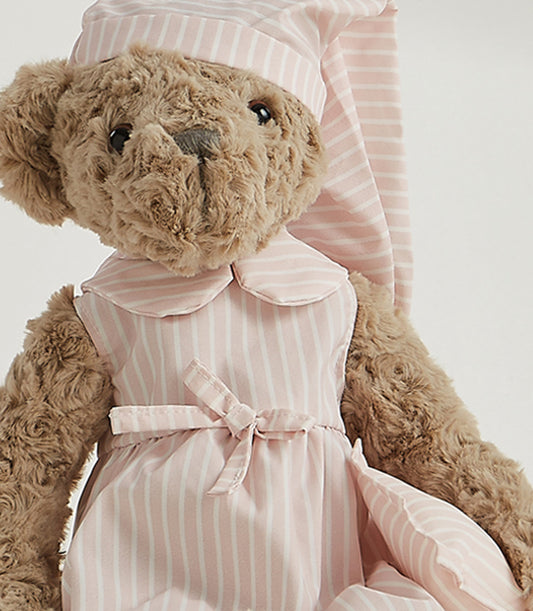 Soft plush teddy bear wearing pink and white striped dress with matching sleep cap and bow