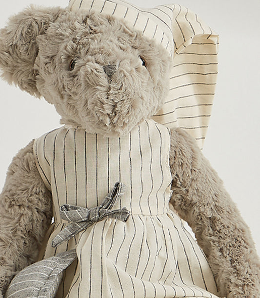 Soft grey teddy bear wearing cream striped nightgown and matching nightcap with bow