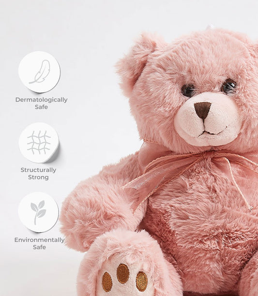 Soft pink plush teddy bear with ribbon bow and dermatologically safe materials