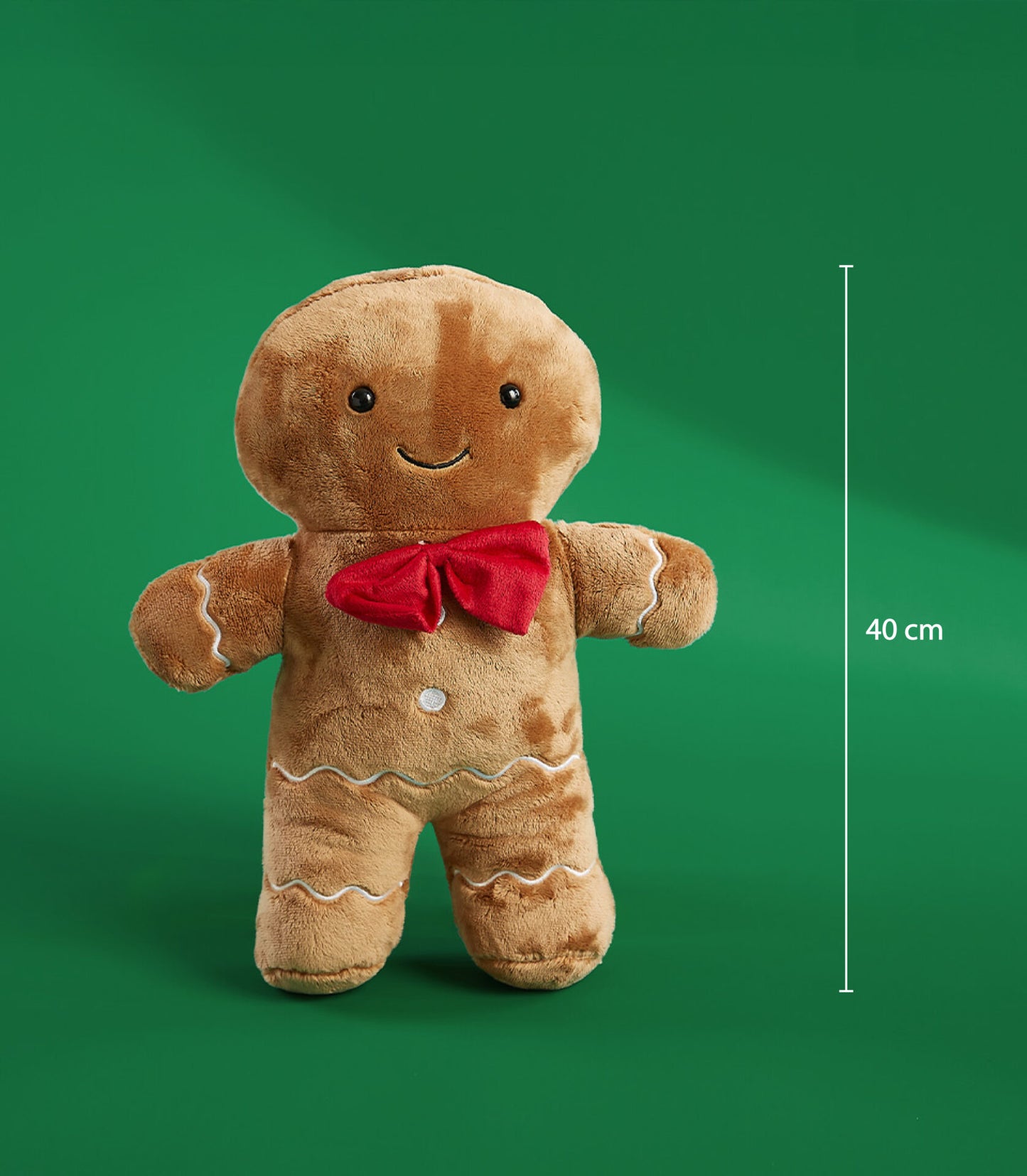 Soft brown plush gingerbread man with embroidered icing details, black smile, and red bow tie, 40 cm tall