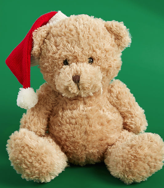 Soft brown teddy bear wearing red and white Santa hat, festive Christmas gift