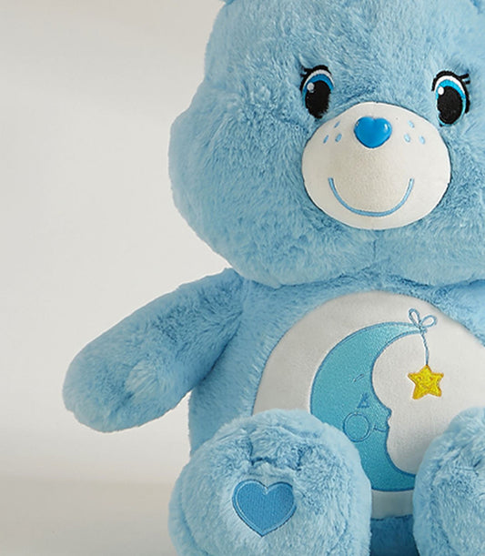 Cozy Dream blue plush bear with embroidered moon belly design and heart details