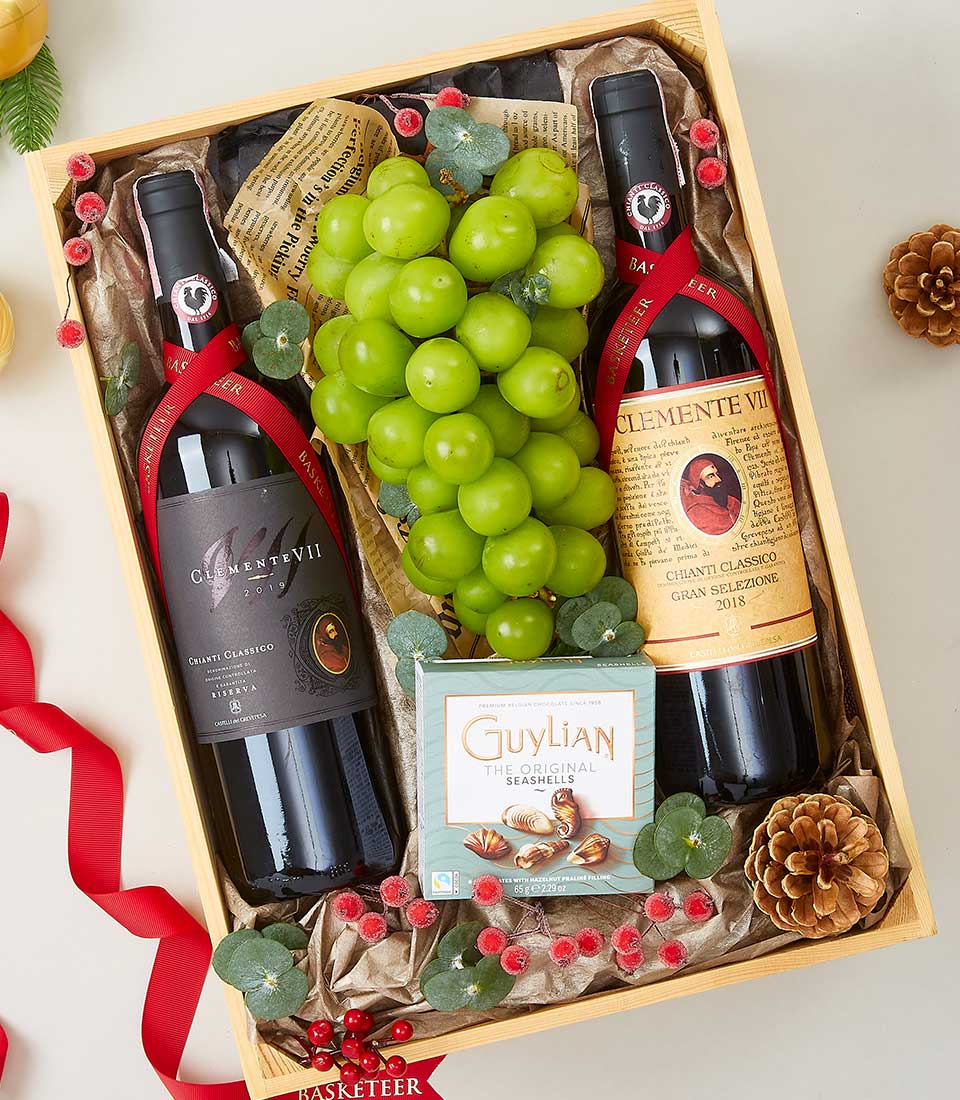 Premium wooden gift box with Clemente VII Chianti wines, Guylian chocolate seashells, fresh green grapes, and festive berry