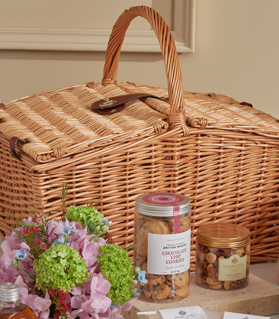 Basketeer high tea gift in a wicker hamper. Features chocolate chip cookies and gourmet mixed nuts. Premium hamper delivery in Thailand.