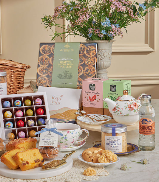 Luxury high tea gift basket with British tartlets, artisan chocolates, shortbread, premium teas, and fresh flowers for New