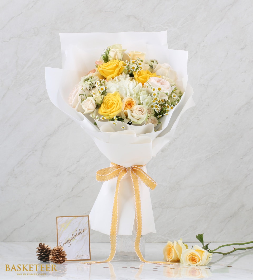 Sunny yellow and white fresh flower bouquet with roses and hydrangeas, gold ribbon accent, perfect for celebrations