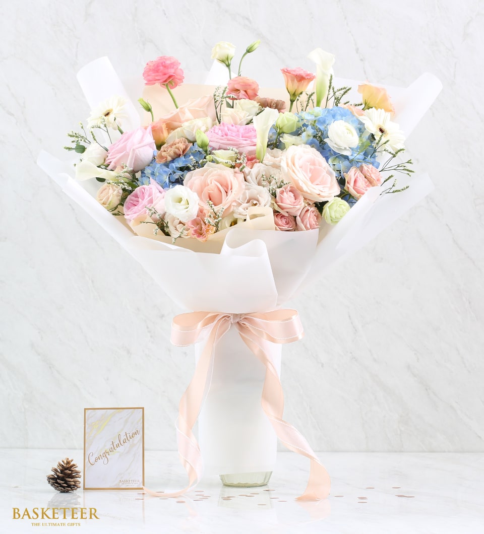 Pastel rose and hydrangea Valentine bouquet with white calla lilies, peach ribbon, and rose gold hearts